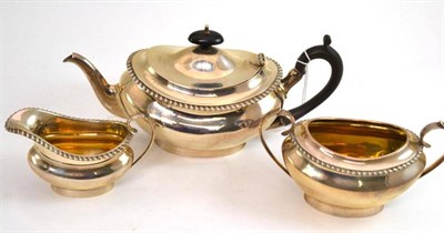 Lot 394 - A late Victorian silver three piece tea service, by EBS Ltd London, each piece of plain oval...