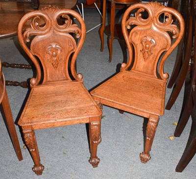 Lot 526 - A pair of Victorian carved oak hall chairs,...