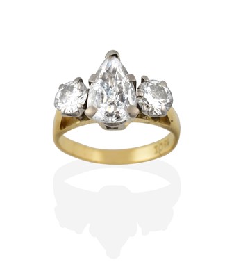 Lot 2338 - A Diamond Three Stone Ring, the pear shaped...