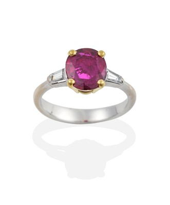 Lot 2343 - A Ruby and Diamond Ring, the oval cut ruby in...