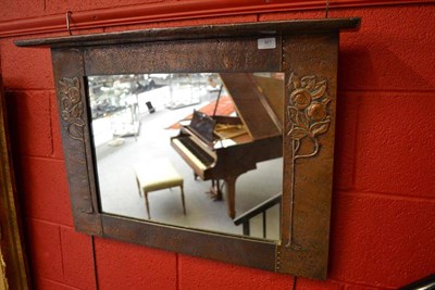 Lot 921 - An Arts & Crafts Hammered Copper Rectangular Overmantel Mirror, repousse decorated with...