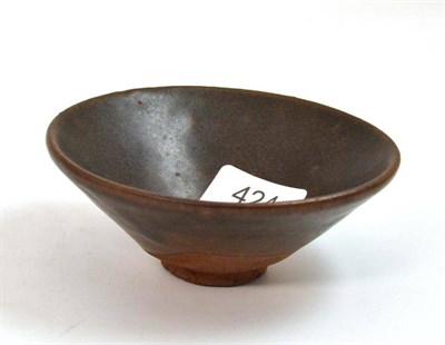 Lot 424 - A Chinese Sung style bowl decorated with a brown glaze