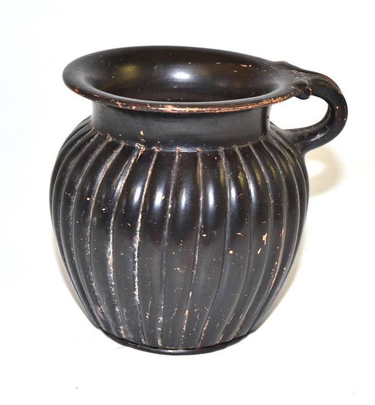 Lot 425 - A Greek black glazed ribbed cup, circa 6th