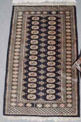Lot 350 - Pakistani Bukhara rug, the ivory field with...