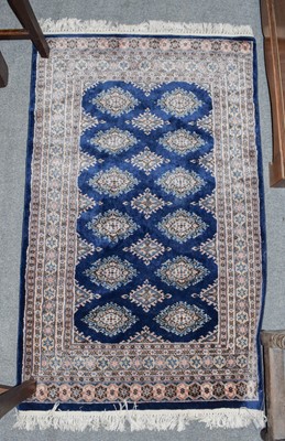 Lot 350 - Pakistani Bukhara rug, the ivory field with...