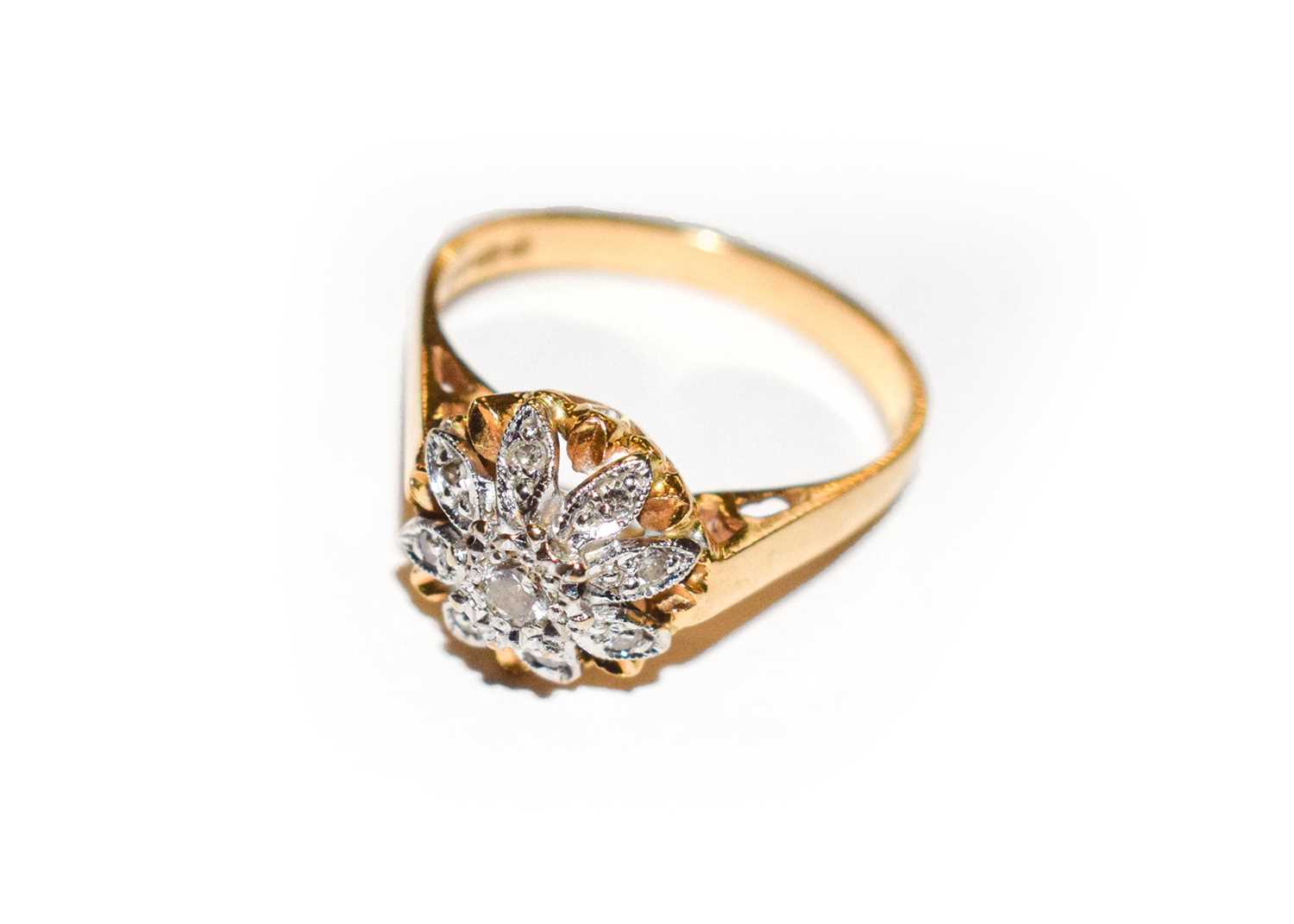Lot 180 - An 18 carat gold diamond cluster ring, finger...