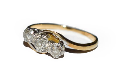 Lot 181 - A diamond three stone twist ring, stamped...