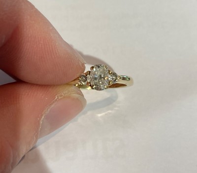 Lot 107 - A diamond three stone ring, stamped ‘14K’,...
