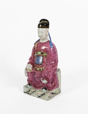 Lot 67 - A Chinese Porcelain Figure of a Seated...