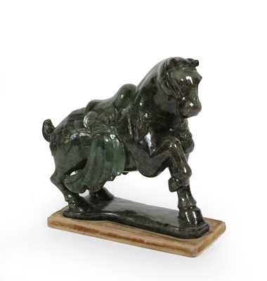Lot 56 - A Chinese Spinach Jade Model of a Horse, in...