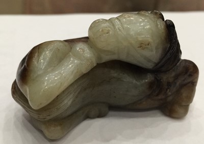 Lot 54 - A Chinese Celadon and Russet Jade Horse, Ming...