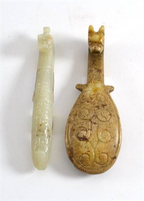 Lot 447 - A Chinese carved hardstone belt hook, carved and engraved with a stylised horse head terminal,...