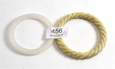 Lot 456 - Two Chinese carved jade type bangles with rope twist design