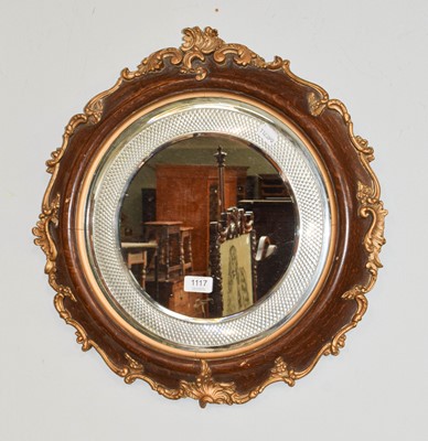 Lot 455 - A circular oak and parcel-gilt framed wall...