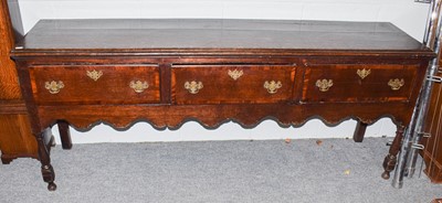 Lot 572 - A George III crossbanded oak dresser base,...