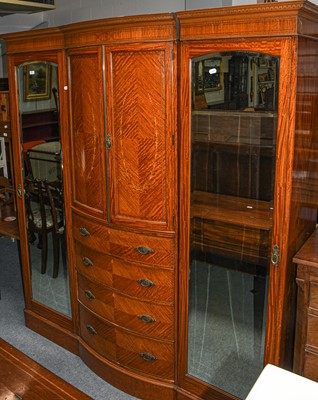 Lot 541 - An Edwardian satinwood breakfront triple...