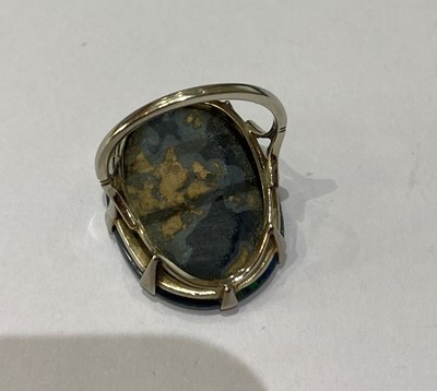Lot 2290 - A Black Boulder Opal Ring, the oval cabochon...