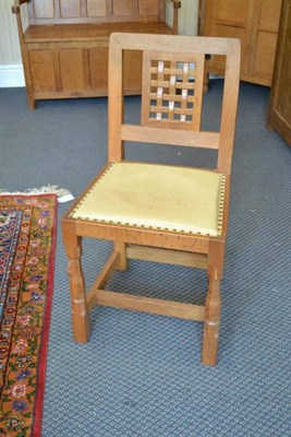 Lot 928 - A Set of Four Robert  "Mouseman " Thompson Oak Lattice Back Chairs, with cream hide seats, on...