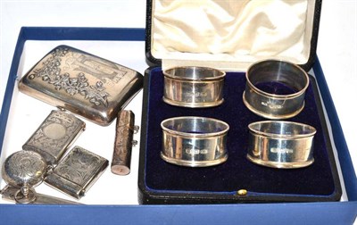 Lot 508 - Cased set of four silver napkins, two silver vestas, silver sovereign holder, silver cigarette case