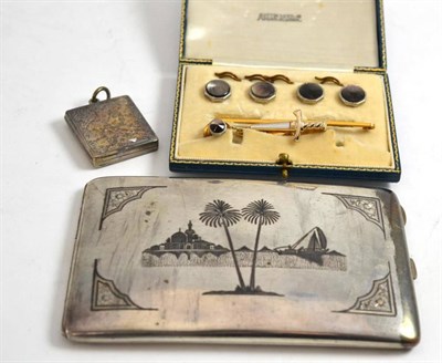 Lot 511 - A cased dress stud set (one stud missing), a sword-shaped tie clip, a 1946 Iraqi cigarette case and