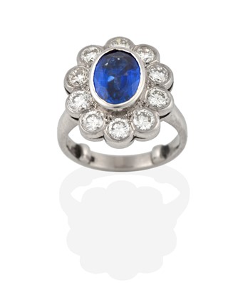 Lot 2381 - A Platinum Sapphire and Diamond Cluster Ring,...