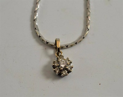 Lot 534 - A diamond cluster pendant on chain