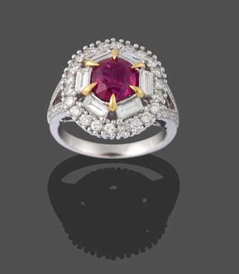 Lot 2400 - A Ruby and Diamond Cluster Ring, the oval cut...