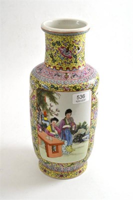 Lot 536 - A Chinese polychrome decorated vase painted with two panels of figures over a yellow ground