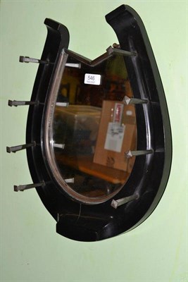 Lot 546 - An unusual Edwardian mirror, the border in the form of a horseshoe, with brass nails for coat hooks