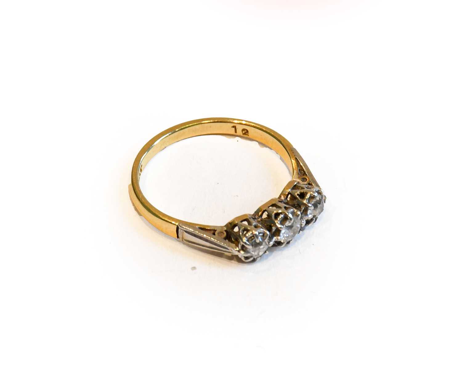 Lot 163 - A diamond three stone ring, stamped '18CT' and...