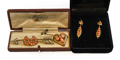 Lot 192 - A coral and seed pearl arrow brooch, unmarked,...