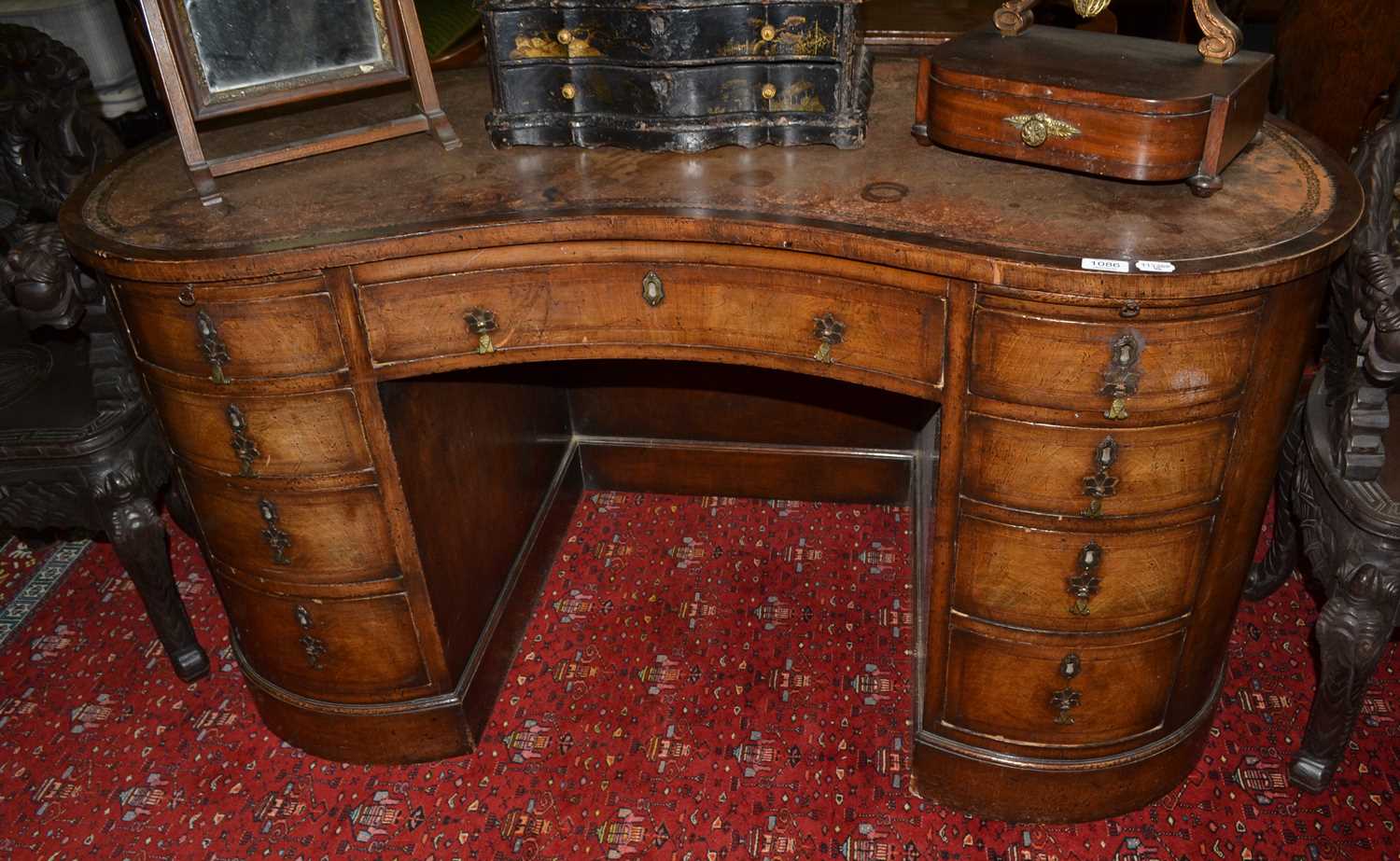 Lot 1086 - A mahogany and leather inset reniform desk,