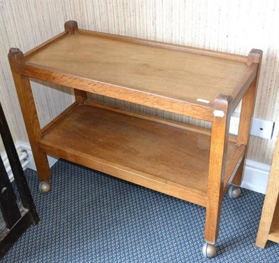 Lot 940 - A Robert  "Mouseman " Thompson Oak Tea Trolley, with two tiers both with raised sides joined by...