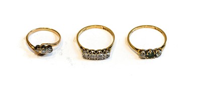 Lot 194 - An 18 carat gold diamond four stone ring,...