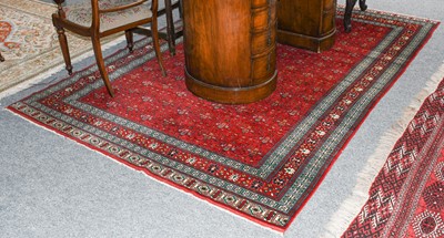 Lot 1130 - A fine-woven Bukhara carpet, the blood red...