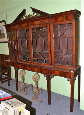 Lot 651 - A mahogany breakfront display cabinet, with astragal glazed doors, raised on associated table...