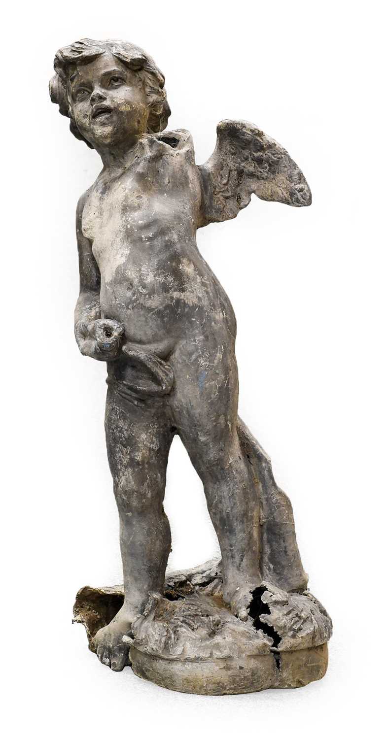 Lot 1078 - A Lead Figure of a Putto, standing on a mound...