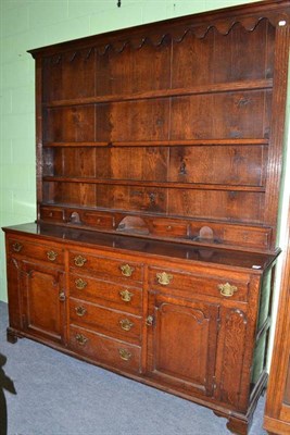 Lot 660 - A 18th century oak dresser and rack, the enclosed base with an arrangement of six drawers and...