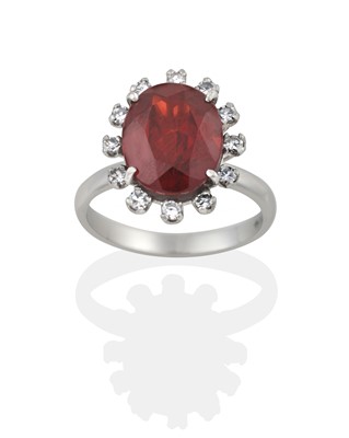Lot 2333 - An Opal Ring and A Garnet and Diamond Cluster Ring