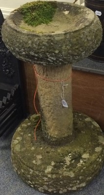 Lot 1110 - A weathered stone birdbath, the top with...