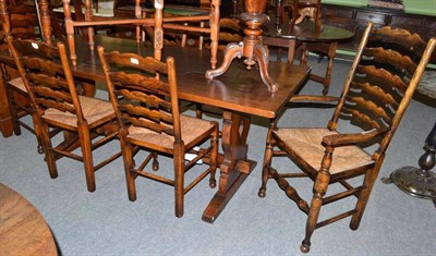 Lot 678 - A reproduction oak refectory table and set of six ladder back rush seated chairs