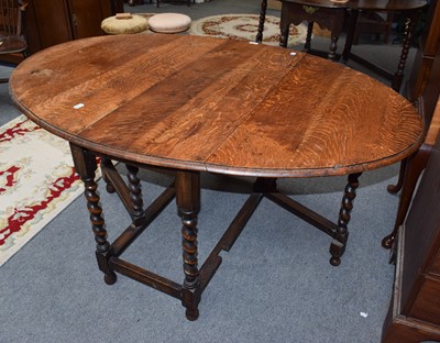 Lot 1204 - An oak drop leaf table on barley twisted...