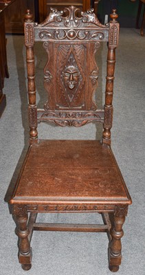 Lot 1207 - A 17th century style carved oak hall chair...