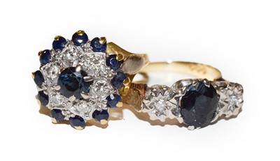 Lot 56 - A sapphire and diamond cluster ring, stamped...