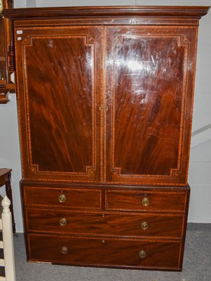 Lot 1284 - A George III mahogany inlaid linen press with...