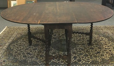 Lot 1102 - A 1920s oak gateleg dining table 190cm by...