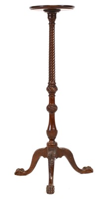 Lot 1335 - A mahogany torchere with wrythen carved...