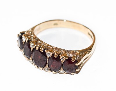 Lot 134 - A 9 carat gold garnet five stone ring, the...