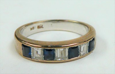 Lot 99 - A sapphire and diamond half hoop ring, stamped...