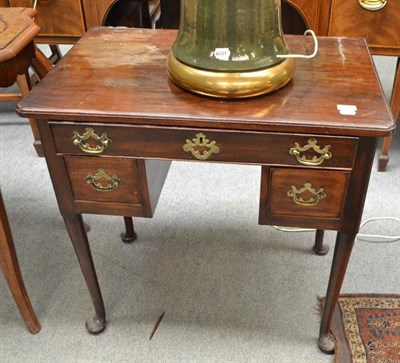 Lot 721 - An 18th century mahogany lowboy with brass handles and pad feet